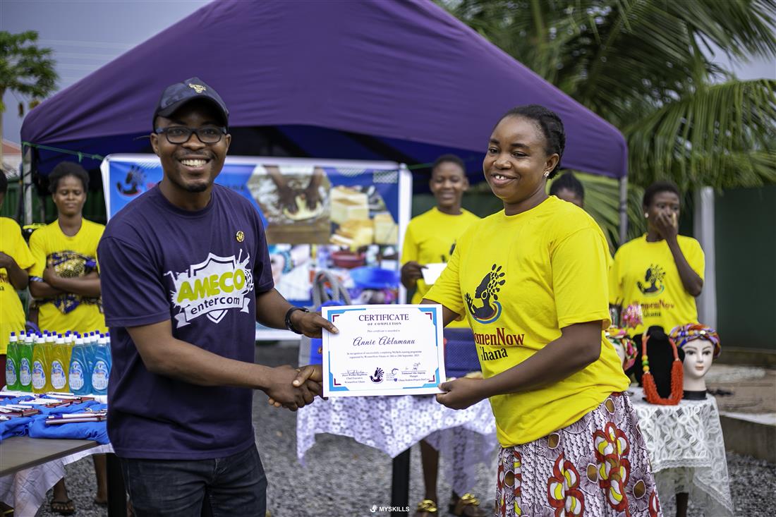 A participant receiving a certificate at an outdoor event