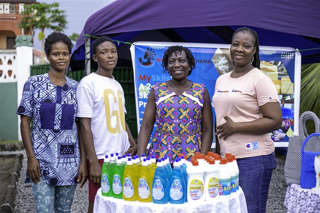 Participants standing behind a display of bottled products